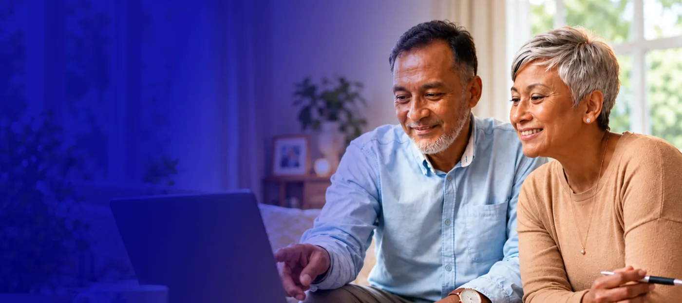 A couple using a laptop together at home
